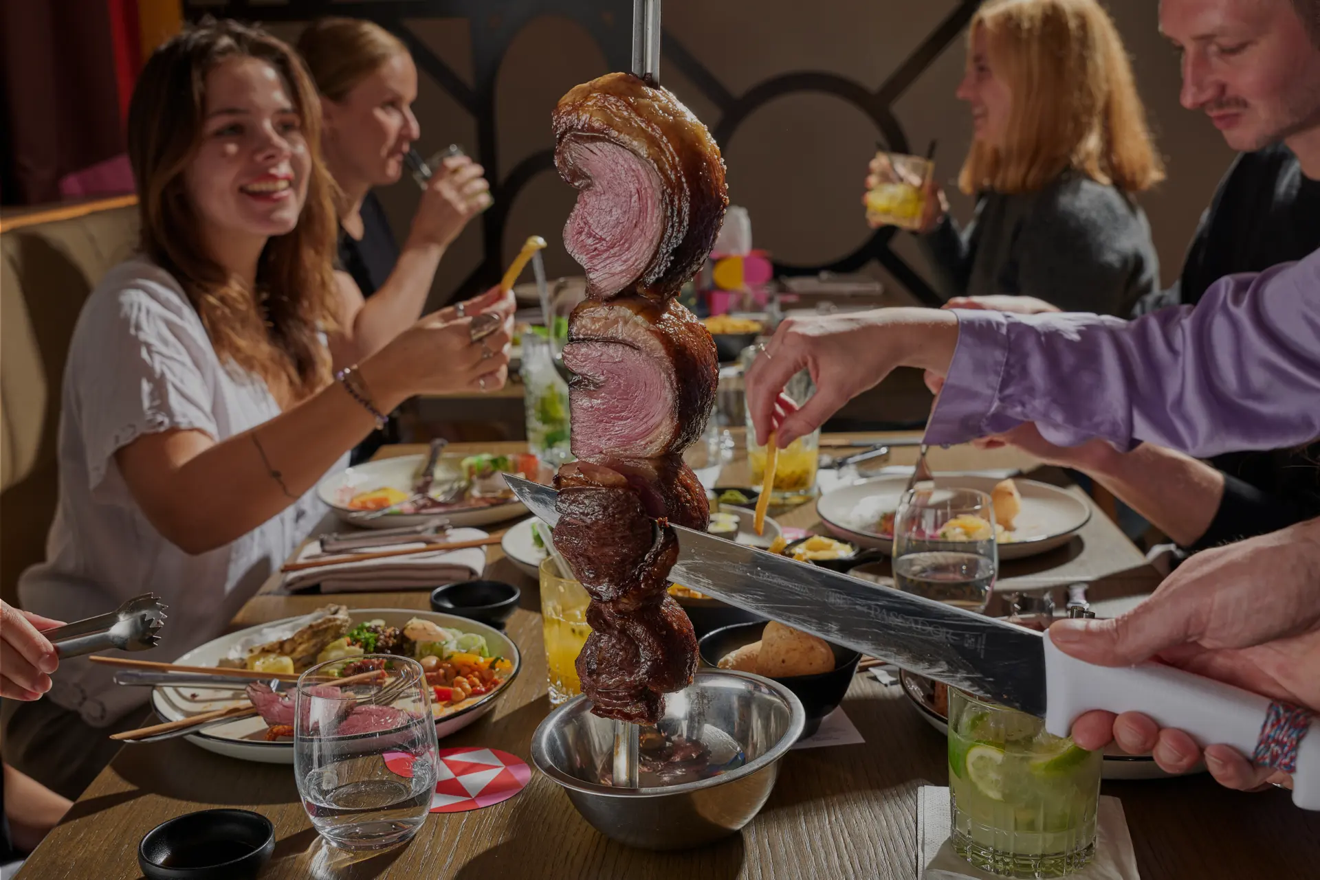 Passadores serving grilled meat tableside at Brasileiro restaurant.